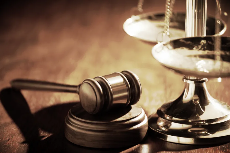 A gavel and brass scales of justice